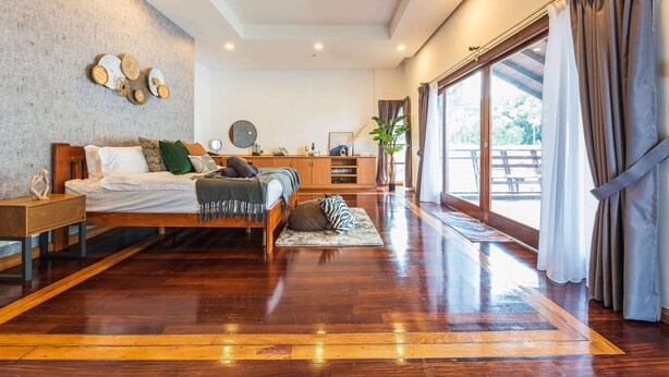 A spacious bedroom with a large bed, wooden flooring, a view through a sliding glass door, and a modern decor. - 30Pax 5BR Luxurious 57ft Pool KL  (Kuala Lumpur)