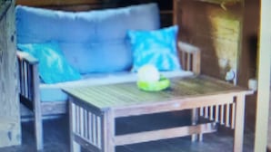 A blurred view of a room with a sofa and a table.
