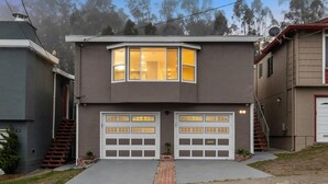 A two-story house with a bay window and two garage doors. - 67 Alta Vista Way (Daly City)