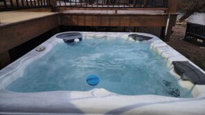 A hot tub with a wooden deck surrounding it. - Waterfront Home, 3 BR, 2 Bath, HOT TUB, Pet-Friendly, Fishing, Fire Pit
  (Murphy)