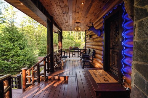 Private log cabin nestled at the base of a secluded wooded area 
