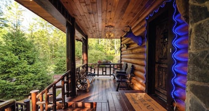 Private log cabin nestled at the base of a secluded wooded area