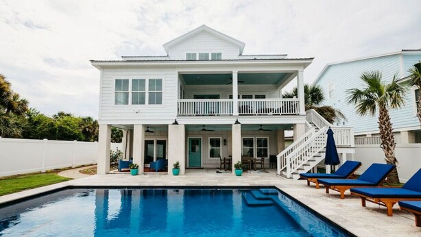 A two-story house with a swimming pool, a covered patio, and a balcony. - Tybee Beach House & Private Pool (Tybee Island)