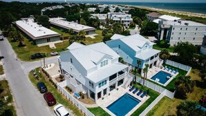 A large, modern house with a swimming pool, multiple garages, and a view of the beach. - Tybee Beach House & Private Pool (Tybee Island)