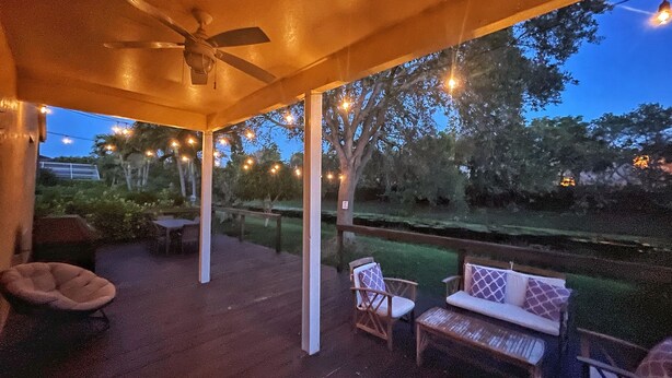 An outdoor patio area with a ceiling fan, string lights, and seating arrangements. - Jupiter's Beacon Villa. Less than 2 miles from the beach in the heart of Jupiter (Jupiter)