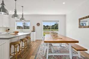 Enjoy cooking in this well-equipped kitchen with a central island and bar stools.