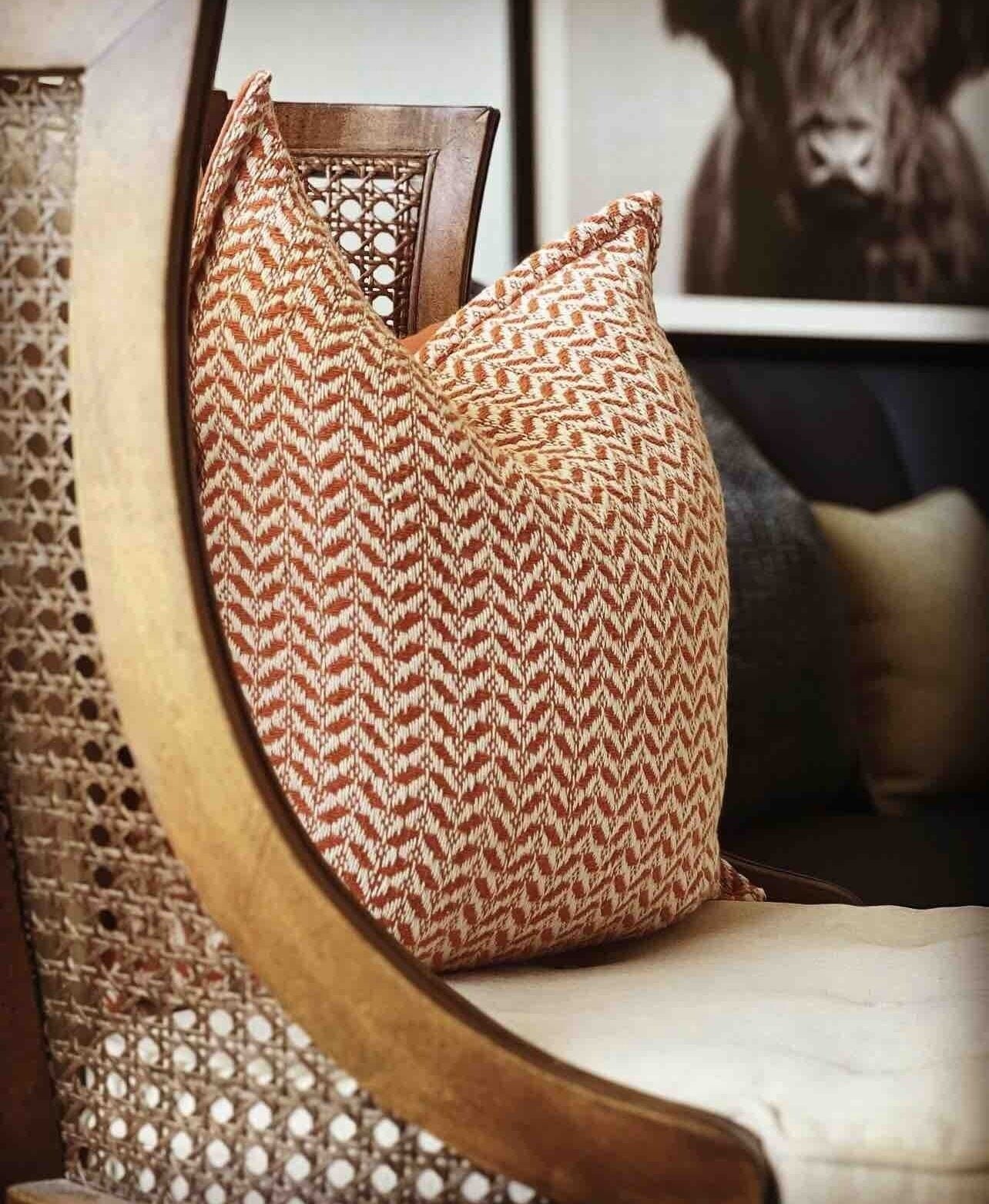A chair with a woven cushion and a wooden chair backrest.