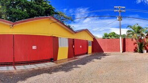 A row of red and yellow buildings with numbered doors, likely a hostel or dormitory. - HOTEL PARAÍSO  (Guaira)