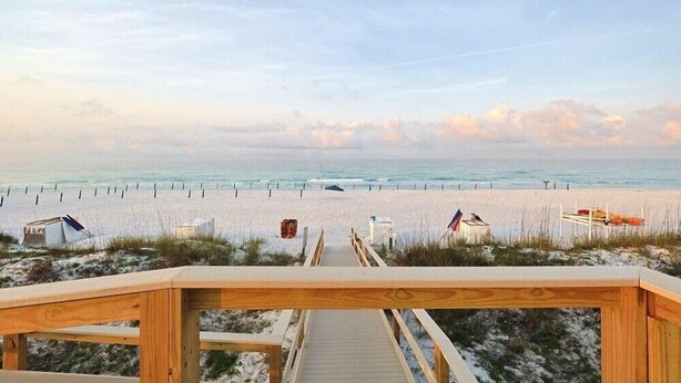 A wooden boardwalk leading to a beach with a clear view of the ocean. - Private Beach Access! Complementary Beach Service! (Miramar Beach)