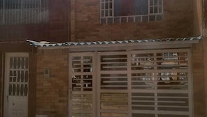A two-story building with a metal gate and a window with bars. - hotel 51b (Bogotá)