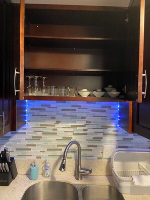 Fridge, microwave, coffee/tea maker, cookware/dishes/utensils
