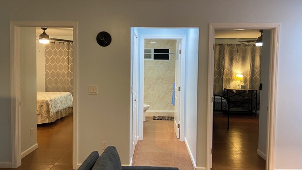 A living room with a sofa, a hallway leading to a bathroom, and a dining area with a table and chairs. - 2bedrm/1bathrm, near shopping center and freeway  (Honolulu)