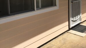A house with a large window, a door with a number, and a small porch area. - 2bedrm/1bathrm, near shopping center and freeway  (Honolulu)