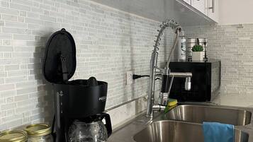 Microwave, coffee/tea maker, toaster, cookware/dishes/utensils