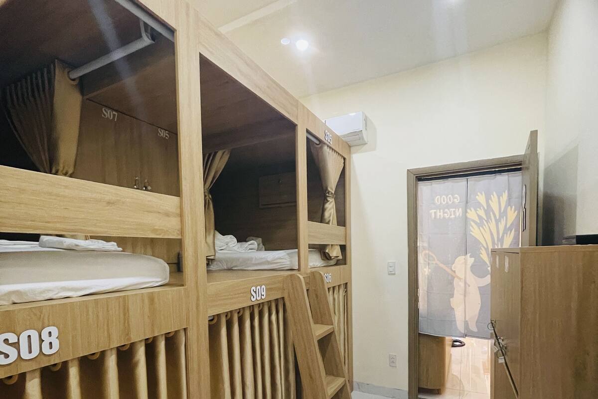 A room with bunk beds, a wardrobe, and a door with a decorative design.
