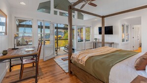 A spacious bedroom with a large bed, wooden ceiling beams, and a view of the outdoors. - Whiteside Perch - Updated Home w/ Huge Views! Close to Everything!  (Highlands)