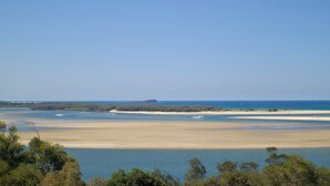 A coastal landscape with a sandy beach and a clear blue sky. - RIVERVIEWS@The Cosmopolitan Unit 20805 (Sunshine Coast)