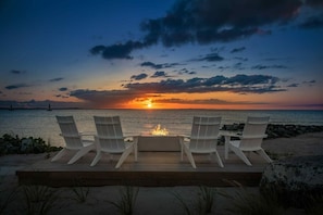 Relax on the beach with a fire pit and ocean views.