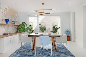 Enjoy meals in this stylish dining area with a large table, comfortable chairs, and a world map on the wall.