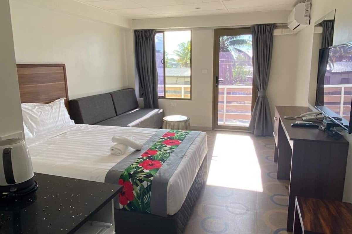 laptop workspace, blackout curtains, iron/ironing board, bed sheets