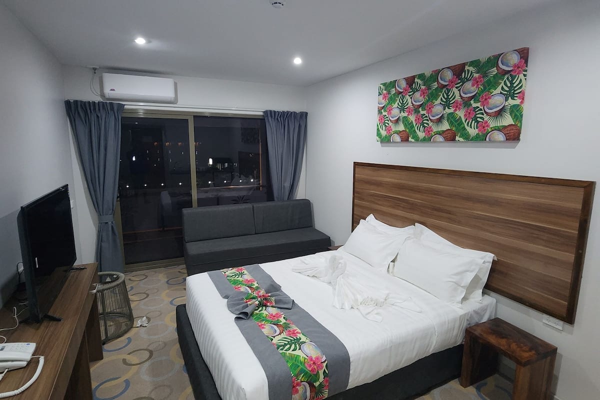 laptop workspace, blackout curtains, iron/ironing board, bed sheets