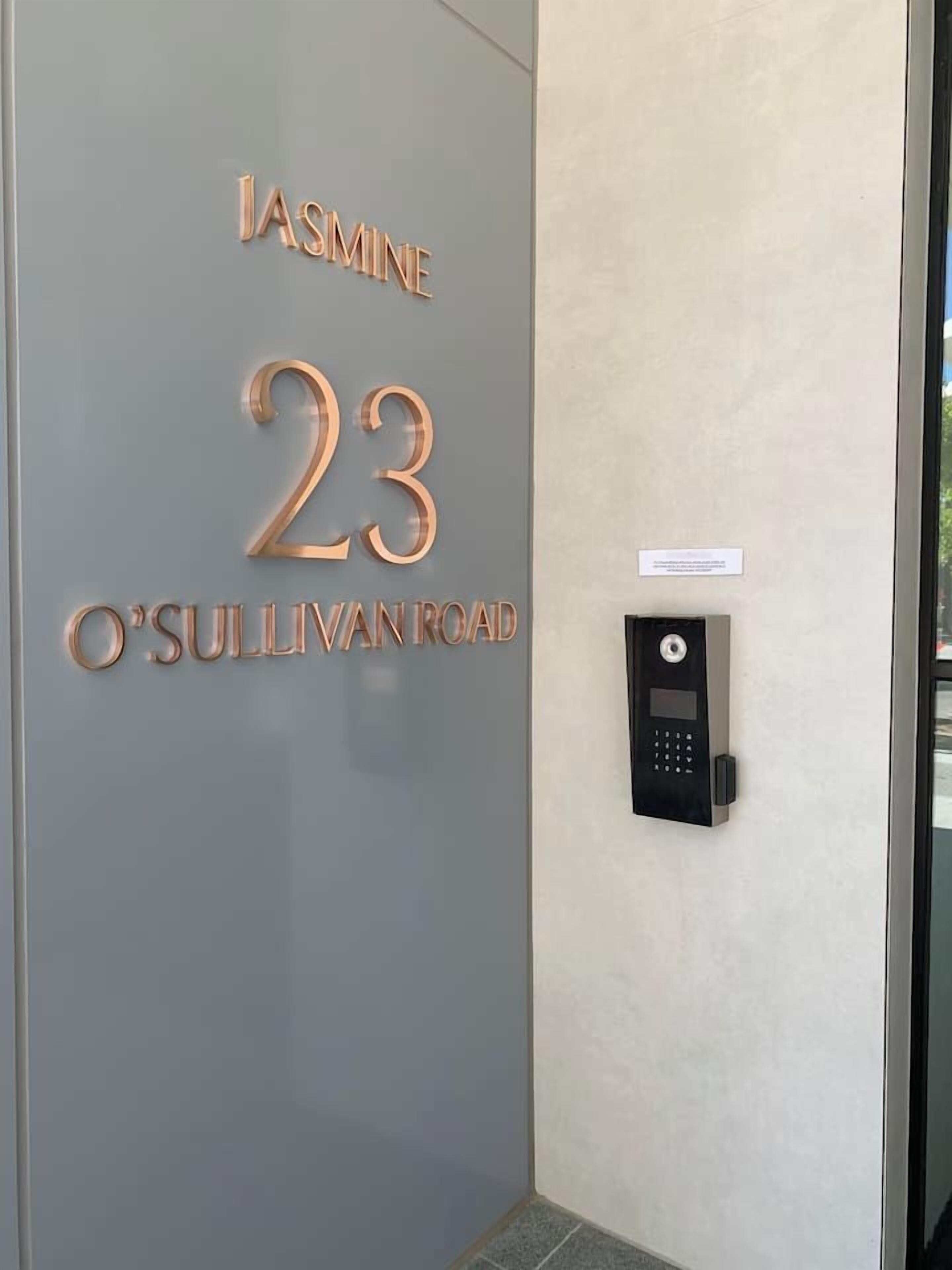 A door with 'Jasmine 23 O'Sullivan Road' and a keypad lock.