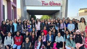 A group of people posing in front of a building with a sign that reads "Amazing Fun World." - Amazing Fun World By Nexottel (Dwarka)