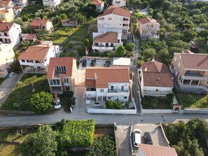 Vista aérea de una zona residencial con casas, una carretera y áreas verdes.