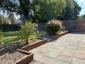 Enjoy a serene outdoor space surrounded by lush gardens and mature trees.