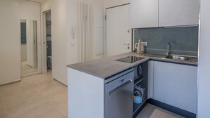 A modern kitchen with a built-in dishwasher, a kettle, and a sink. - Calm 1BR Apt renovated with terrace and WiFi in Menton (Menton)