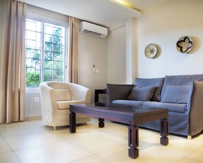 Apartamento luxo, 1 quarto | Área de estar | TV de tela plana 32 polegadas com canais digitais