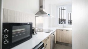 A modern kitchen with a built-in microwave, toaster, and dishwasher.