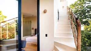 A modern interior with a staircase, a bed, and a glass door leading to a balcony. - Studio Ph Private Rooftop Pool Great Located (Tulum)