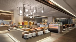 A modern hotel lobby with a buffet area, a reception desk, and a seating area. - Wyndham Sun Moon Lake (Yuchi)