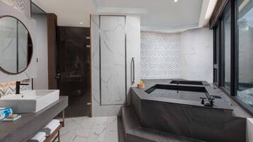 Enjoy a refreshing soak in the bathtub with a view of the surrounding area.