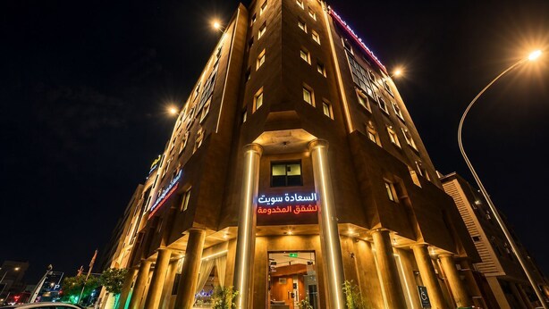 A multi-story hotel with a prominent entrance, large columns, and illuminated signage. - السعاده سويت للشقق المخدومه (Riyadh)