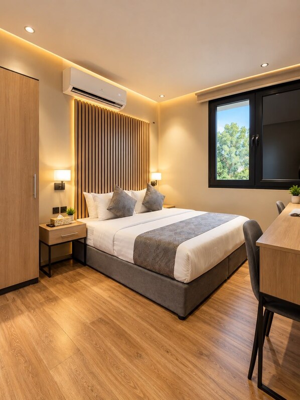 A modern bedroom with a large bed, bedside tables, a desk, and a window with a view. - السعاده سويت للشقق المخدومه (Riyadh)