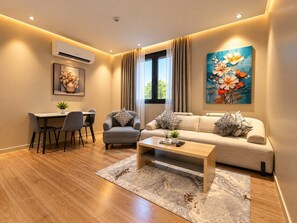 A modern living room with a sofa, armchair, dining table, and coffee table. - السعاده سويت للشقق المخدومه (Riyadh)