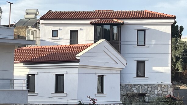 A two-story building with a red-tiled roof, stone foundation, and multiple windows. - Agon Ephesus  (Selçuk)
