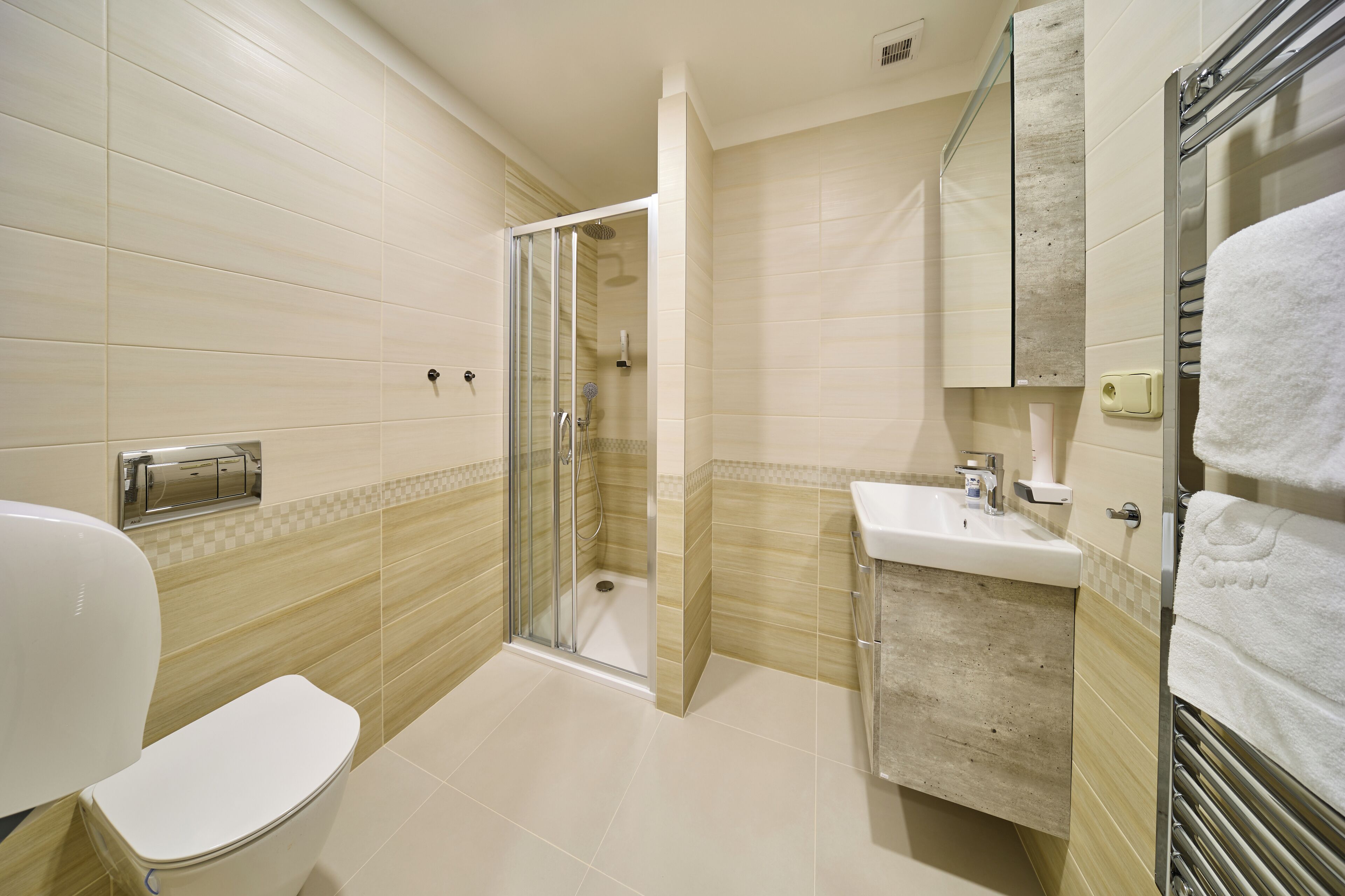 A bathroom with a toilet, sink, and shower area.