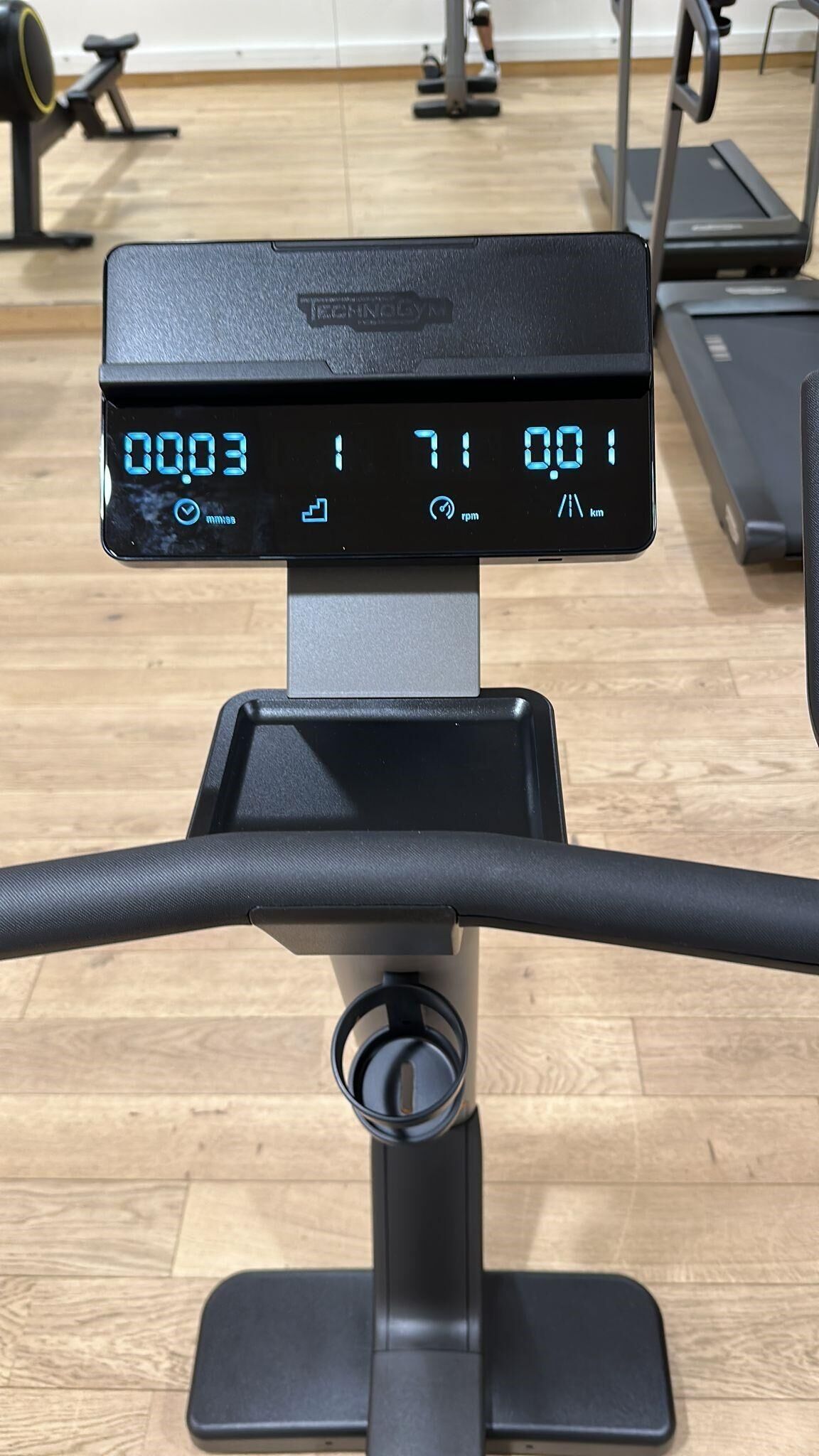 A stationary bike with a digital display showing 0.03 miles, 71 rpm, and 0.0 km.