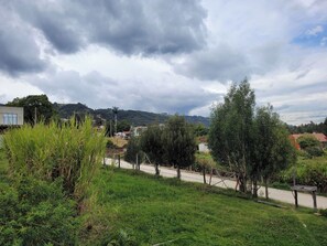 Surrounded by lush trees and rolling hills, this serene landscape offers a peaceful escape.
