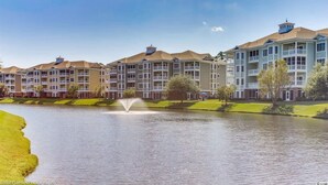 A multi-story hotel with balconies, a central courtyard, and a fountain. - Book your Spring Golf Vacations. Summer Beach vacations are here too.  (Myrtle Beach)