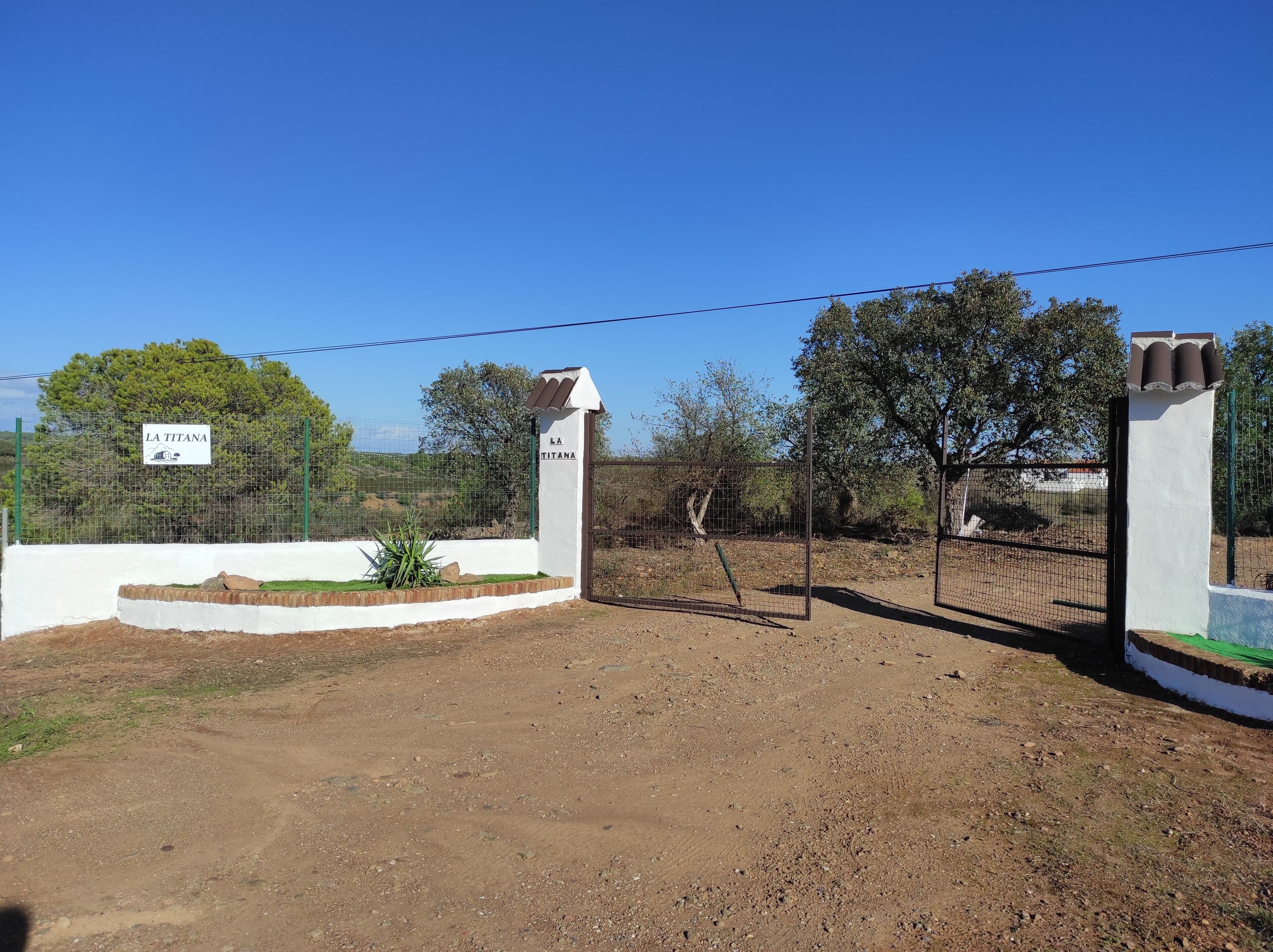 A fenced property with a sign reading "LA TITANA".