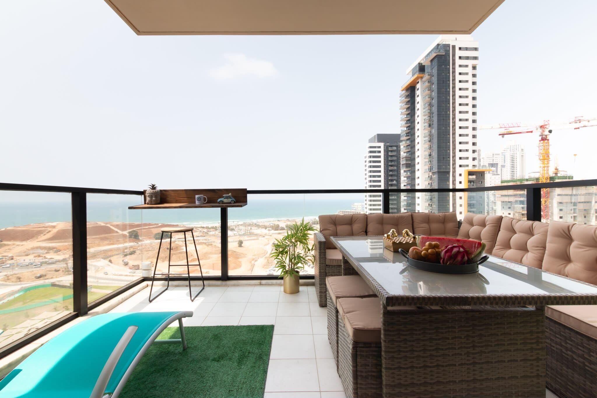 Spacious balcony lounge with sea views invites sunset dining and relaxed evenings near lively beach promenade.