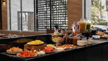 A buffet with various food items and beverages.