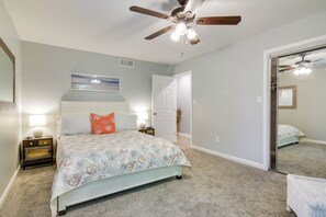 A bedroom with a bed, nightstands, a ceiling fan, a door, and a mirror. - 5 Mi to Rehoboth Beach: Home w/ Backyard! (Rehoboth Beach)