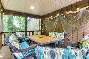 A covered patio area with wicker furniture, a table, and a hammock. - 5 Mi to Rehoboth Beach: Home w/ Backyard! (Rehoboth Beach)