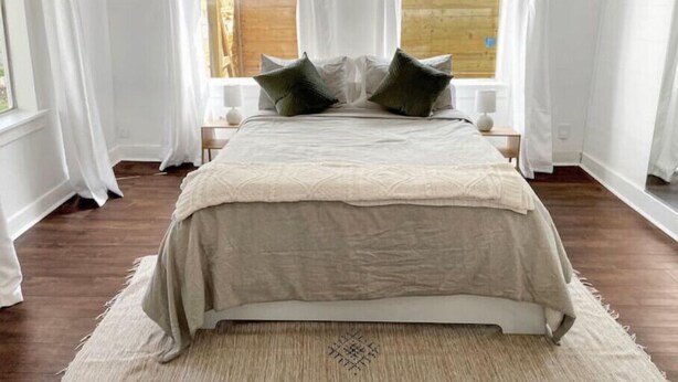 A bedroom with a large bed, white curtains, and a view of the outside. - Best neighborhood in SA! Near it all, food & fun!
 (San Antonio)