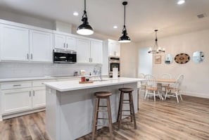 Enjoy meals in this well-equipped kitchen with a central island and stainless steel appliances.